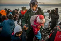 Refugiados y migrantes llegan a la isla griega de Lesbos después de cruzar en un bote el mar Egeo desde Turquía, en marzo de 2020.