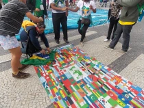 Mike Alvarado (de rodillas) muestra la bandera que ya tiene algunas decenas de firmas (foto ACI Prensa)