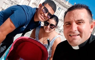 El P. Bladimir Navarro con un matrimonio de cubanos ayudados por el Proyecto Cobijo. Cru00e9dito: Cortesu00eda Proyecto Cobijo 