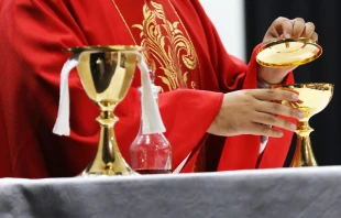 Sacerdote con vestiduras litu00fargicas de color rojo. Cru00e9dito: Shuterstock 