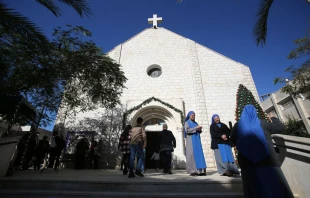 Los fieles cristianos palestinos se reúnen mientras asisten a una ceremonia dentro de la Iglesia de la Sagrada Familia, en la ciudad de Gaza, el 19 de diciembre de 2021. Crédito: Anas-Mohammed - Shutterstock
