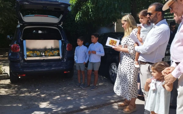 Una familia espera a recoger el cuerpo de su hijo, poco antes de enterrarlo. Crédito: En Vela