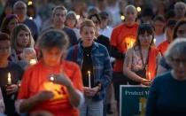 Personas asisten a una vigilia en el Parque Lynnhurst para lamentar a los fallecidos y orar por los heridos después de que un hombre armado abriera fuego contra estudiantes de la Escuela Católica de la Anunciación el 27 de agosto de 2025 en Minneapolis.