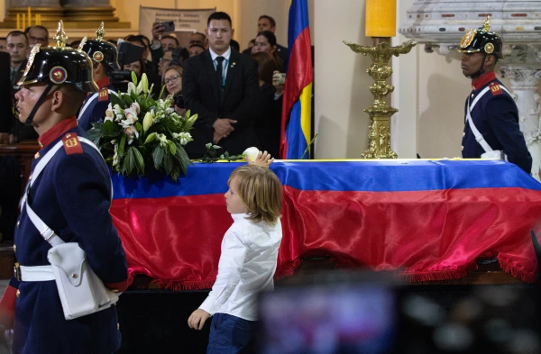 El hijo de Miguel Uribe Turbay coloca la primera de varias rosas sobre el ataúd. Crédito: Eduardo Berdejo / EWTN.