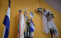 Dentro de la iglesia de San Miguel, estatuas y un crucifijo llevan referencias a la bandera de Nicaragua, símbolo de las protestas contra el gobierno de Daniel Ortega, en Masaya, Nicaragua, el 25 de junio de 2019.
